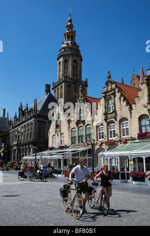 Grote Markt with cyclists,restaurants and Saint Walburga`s Church tower (Saint Walburgakerk) in town of Veurne, Belgium Stock Photo